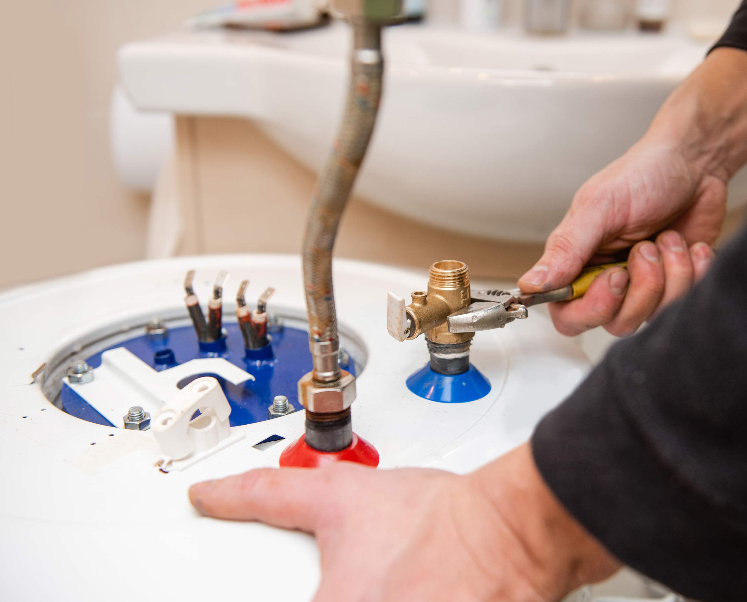 a man is cutting into a sink