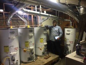 A George Salet Plumbing technician servicing American Standard water heaters