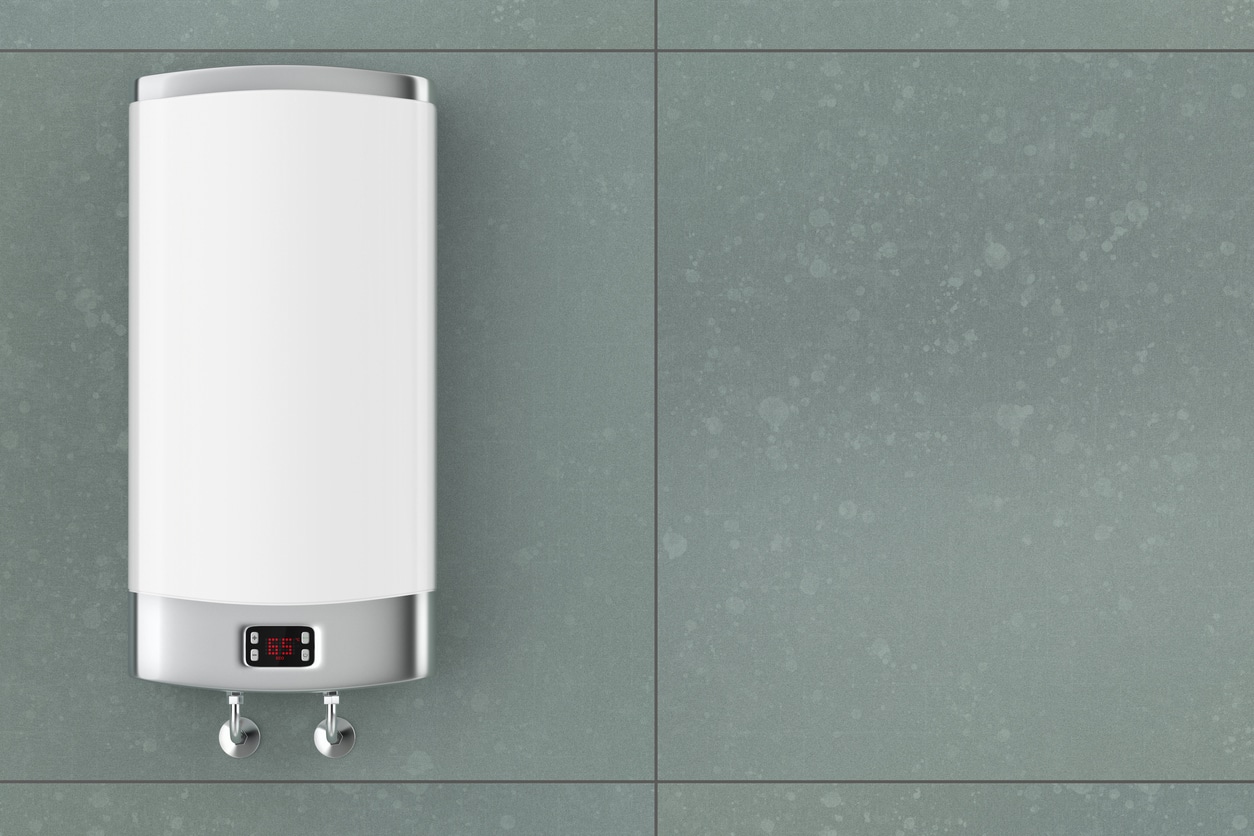 A white electric tankless water heater installed on a large teal tile wall in a San Francisco home.